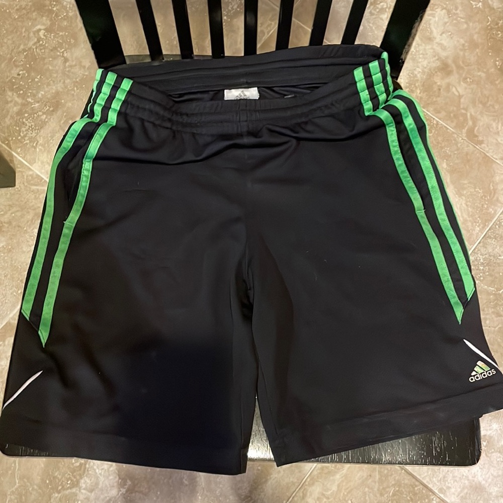 Boys Adidas size small black and green shorts.
